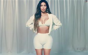 Enticing Kim Kardashian shows off her figure in a white hot outfit